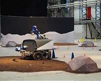 An astronaut controls a rover on Earth