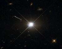 Gas Clouds Whirling Around Black Hole in Distant Quasar