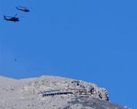 Rescuers rush to reach dozens trapped on erupting Japan volcano