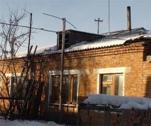 Owner of house hit by satellite fixes roof himself amid compensation snag