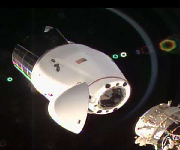 SpaceX resupply cargo capsule docks with International Space Station