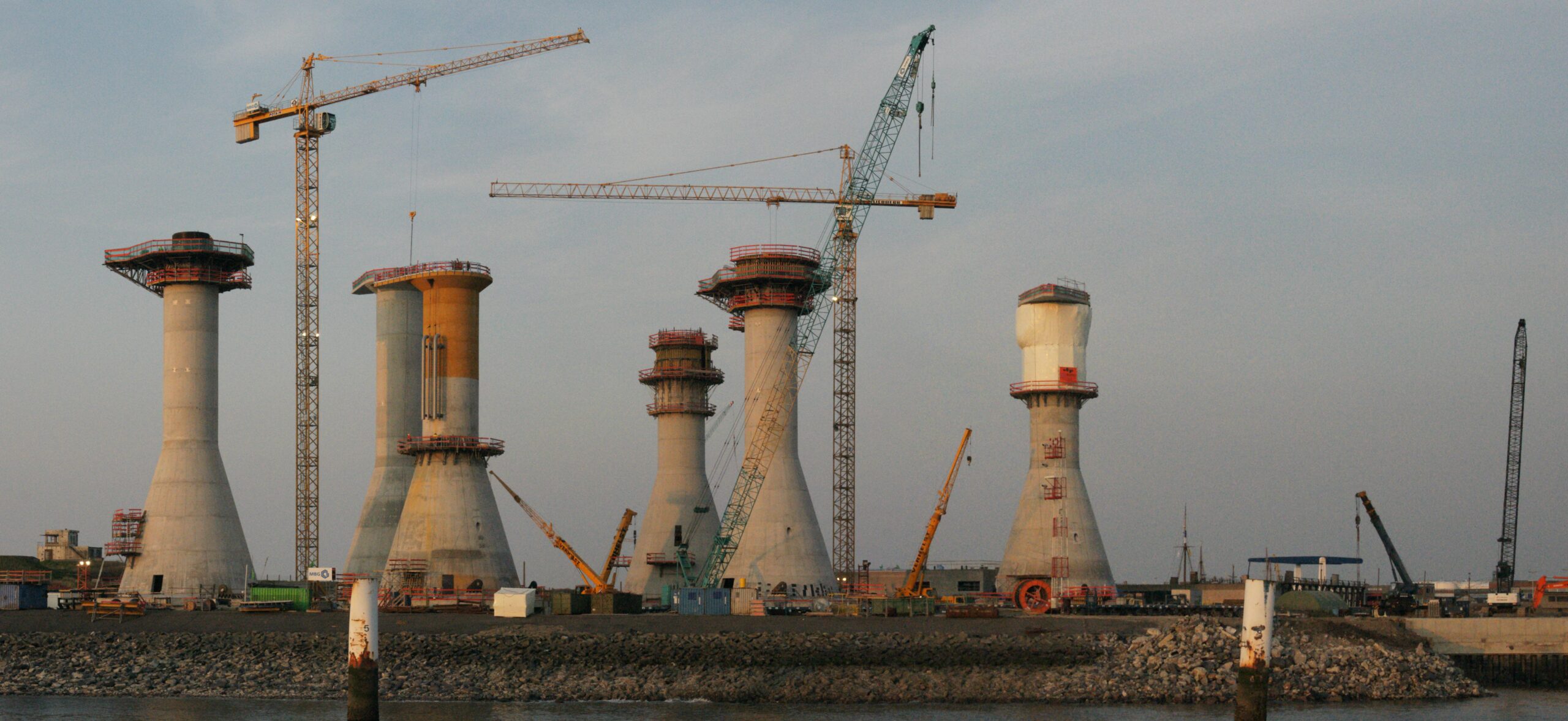 In April 2025 the first of 23 concrete caissons, each about 22,000 tonnes, was floated out for Belgium's Princess Elisabeth Island 45 km offshore; cost estimates have since climbed towards €7 billion